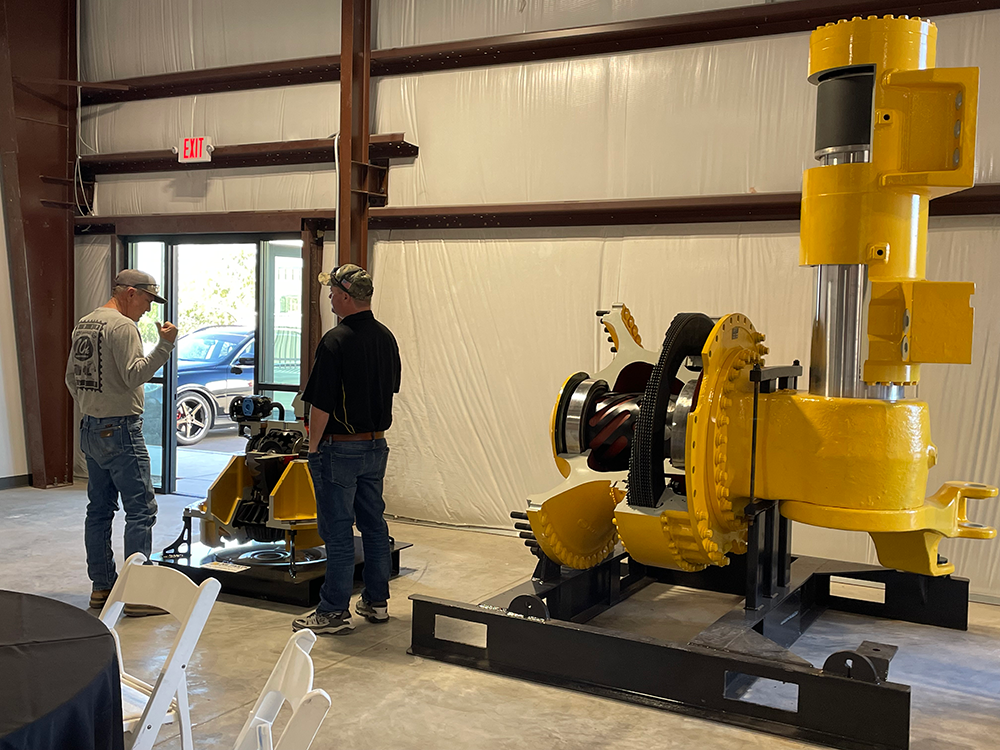 H-E Parts employee discussing display model during Tucson open house